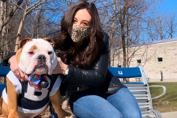 Taylor Tannebaum  posing with her pet dog 